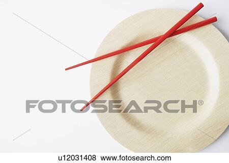Stock Photo - Close-up of a pair of chopsticks on a plate. Fotosearch