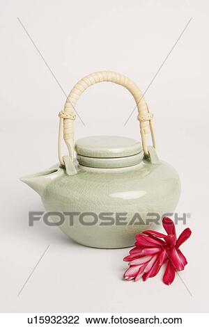 Stock Image - Close-up of a tea kettle with a flower. Fotosearch