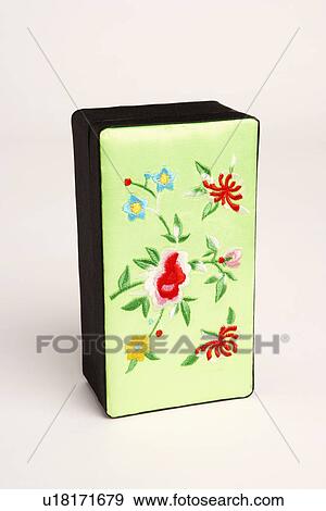 Stock Photo - Close-up of flowers embroidered on a box. Fotosearch