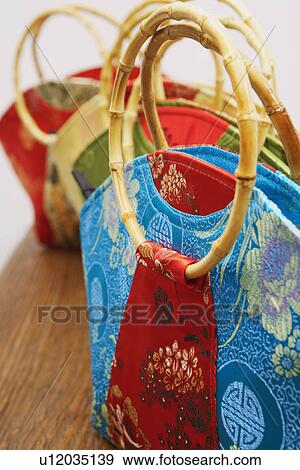Stock Photo - Close-up of four hand bags in a row. Fotosearch