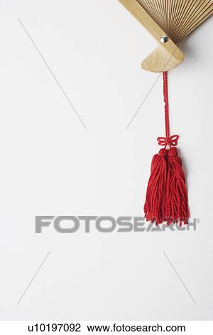 Stock Image - Close-up of the tassel of a folding fan. Fotosearch