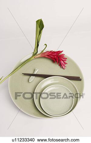 High angle view of a flower and chopsticks in a plate View Large Photo Image Stock Image - High angle view of a flower and chopsticks in a plate. Fotosearch