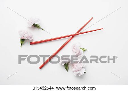 High angle view of a pair of chopsticks and flowers View Large Photo Image Picture - High angle view of a pair of chopsticks and flowers. Fotosearch