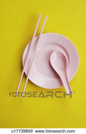 Stock Photo - High angle view of a plate and a spoon with chopsticks. Fotosearch