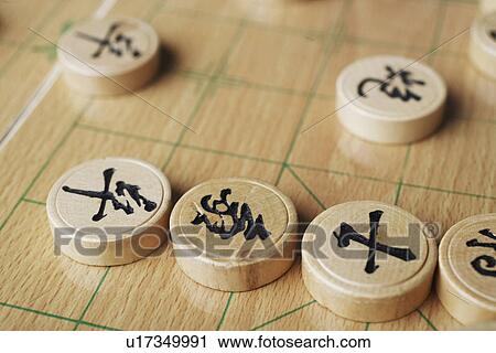 Stock Image - High angle view of Chinese chess pieces. Fotosearch