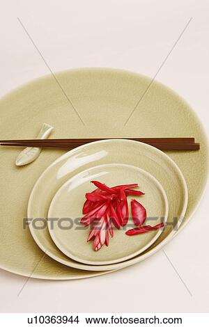High angle view of flower petals and chopsticks in a plate View Large Photo Image Picture - High angle view of flower petals and chopsticks in a plate. Fotosearch