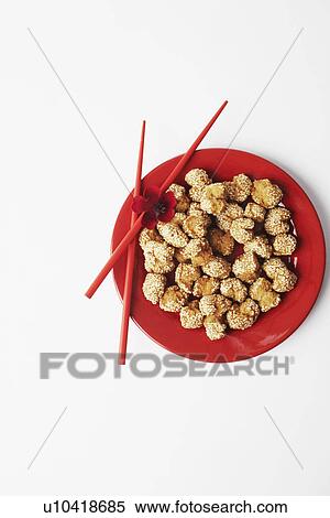 Stock Photography - High angle view of food in a plate with a pair of chopsticks. Fotosearch