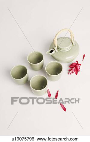 High angle view of four tea cups and a tea kettle with flower petals View Large Photo Image Stock Photograph - High angle view of four tea cups and a tea kettle with flower petals. Fotosearch