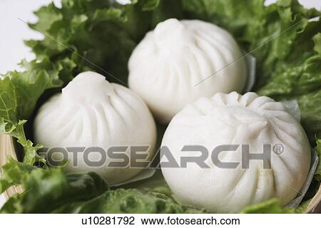 Stock Image - High angle view of steamed dumplings. Fotosearch