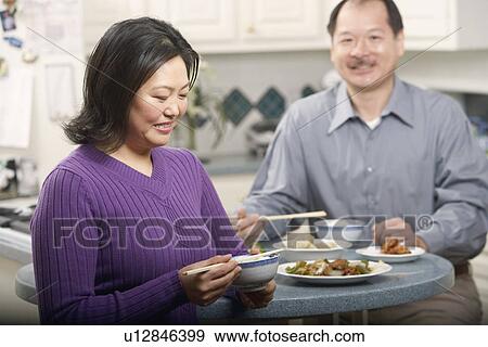 Stock Photo - Close-up of a couple eating food. Fotosearch