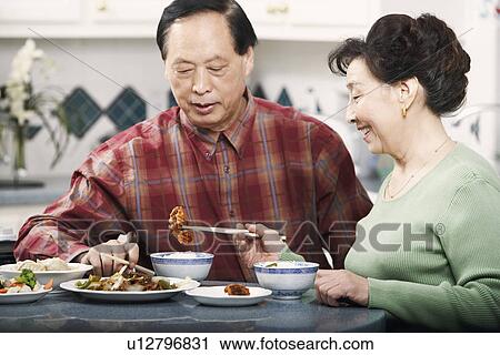 Close-up of a senior couple sitting at a table View Large Photo Image Stock Image - Close-up of a senior couple sitting at a table. Fotosearch