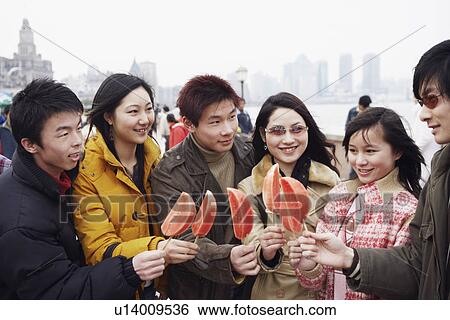Close-up of three young men and three young women holding watermelons View Large Photo Image Stock Photograph - Close-up of three young men and three young women holding watermelons. Fotosearch