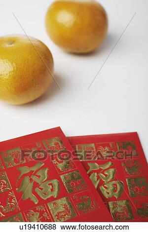 Stock Photo - High angle view of two oranges with two envelopes. Fotosearch