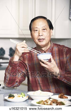 Portrait of a senior man eating food View Large Photo Image Stock Photography - Portrait of a senior man eating food. Fotosearch