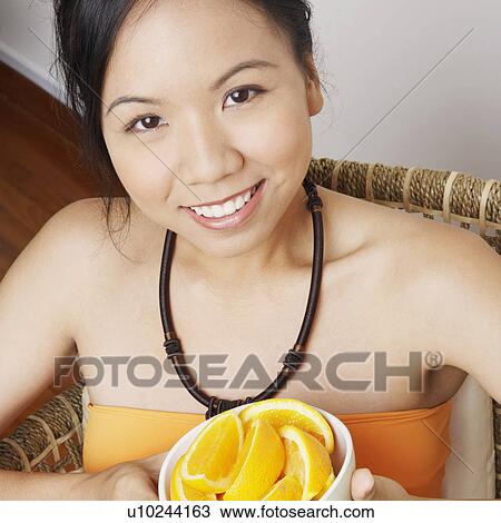 Portrait of a young woman holding a bowl View Large Photo Image Stock Image - Portrait of a young woman holding a bowl. Fotosearch