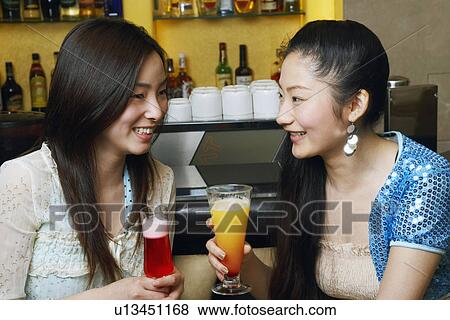 Close-up of two friends looking at each other View Large Photo Image Stock Photo - Close-up of two friends looking at each other. Fotosearch