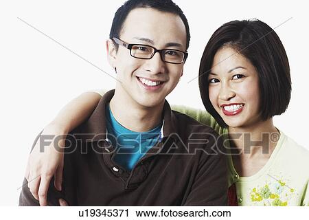 Stock Image - Portrait of a young couple smiling. Fotosearch