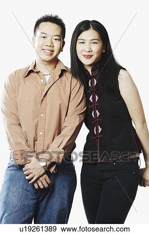 Stock Photo - Portrait of a young couple smiling. Fotosearch