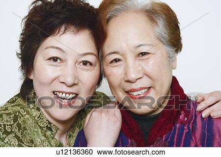 Portrait of two mature women smiling View Large Photo Image Stock Image - Portrait of two mature women smiling. Fotosearch
