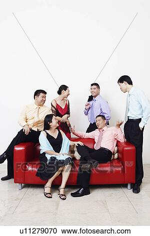Stock Image - Group of business executives talking. Fotosearch