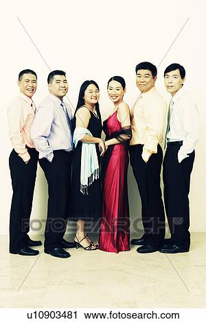Stock Image - Portrait of a group of business executives standing in a row and posing. Fotosearch