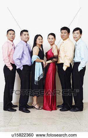 Stock Image - Portrait of a group of business executives standing in a row and posing. Fotosearch