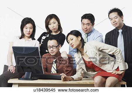 Portrait of a group of business executives in front of a computer View Large Photo Image Stock Photography - Portrait of a group of business executives in front of a computer. Fotosearch