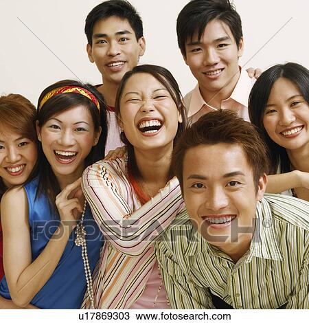 Stock Image - Portrait of a group of people standing together and smiling. Fotosearch