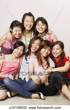 Stock Image - Portrait of a group of young women posing. Fotosearch