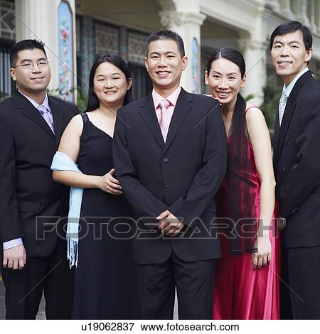 Stock Photo - Portrait of four businessmen and two businesswomen standing. Fotosearch