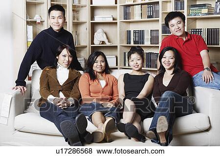 Portrait of four young women and two young men sitting on a couch View Large Photo Image Stock Photo - Portrait of four young women and two young men sitting on a couch. Fotosearch