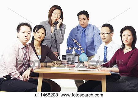 Stock Photo - Portrait of three businessmen and three businesswomen in a meeting. Fotosearch
