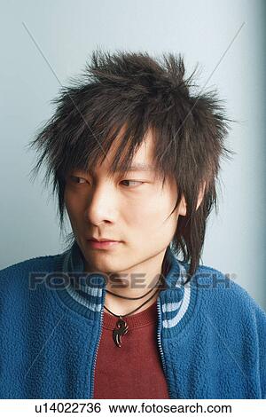 Stock Photograph - Close-up of a young man looking away. Fotosearch