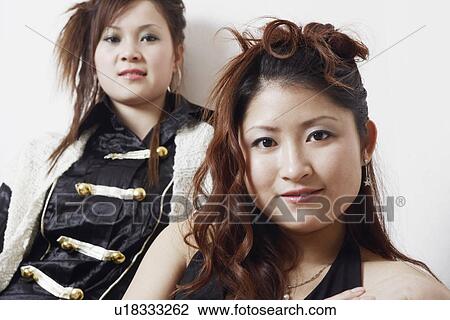 Stock Image - Portrait of a teenage girl and a young woman smiling. Fotosearch