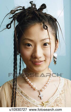 Stock Photo - Portrait of a young woman smiling. Fotosearch