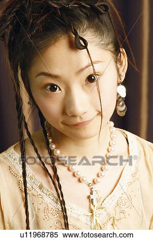 Stock Photography - Portrait of a young woman smiling. Fotosearch