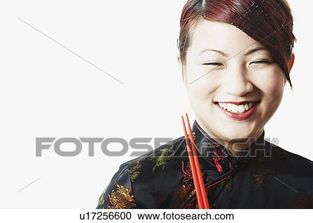 Stock Image - Close-up of a young woman smiling with her eyes closed. Fotosearch