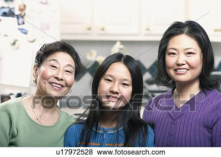 Stock Photo - Portrait of a girl smiling with her mother and grandmother. Fotosearch