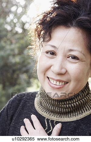 Portrait of a mature woman smiling View Large Photo Image Stock Photography - Portrait of a mature woman smiling. Fotosearch