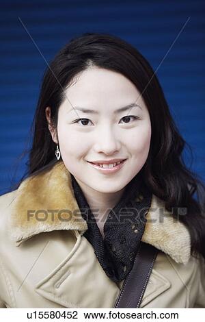 Portrait of a young woman smiling View Large Photo Image Stock Image - Portrait of a young woman smiling. Fotosearch
