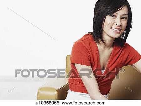 Portrait of a young woman smiling View Large Photo Image Stock Photograph - Portrait of a young woman smiling. Fotosearch
