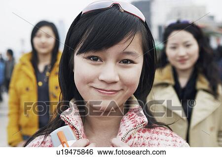 Stock Photograph - Portrait of a young woman smiling. Fotosearch