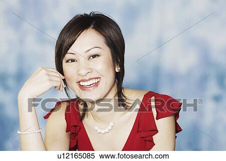 Stock Photography - Portrait of a young woman smiling. Fotosearch