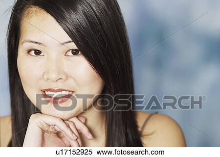 Stock Photography - Portrait of a young woman smiling. Fotosearch
