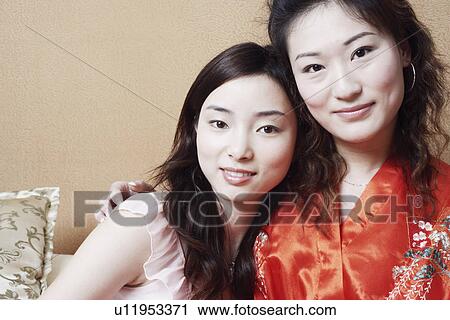 Portrait of two young women smiling together View Large Photo Image Stock Image - Portrait of two young women smiling together. Fotosearch