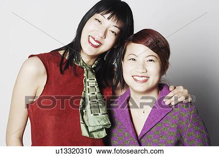 Portrait of two young women smiling View Large Photo Image Stock Image - Portrait of two young women smiling. Fotosearch