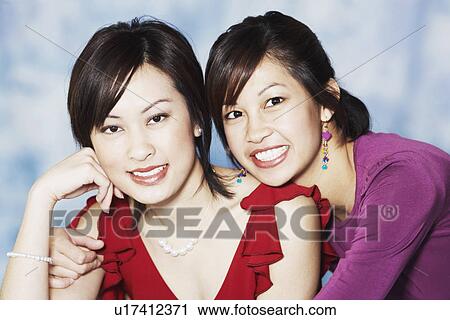 Stock Image - Portrait of two young women smiling. Fotosearch