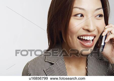 Close-up of a businesswoman talking on a mobile phone View Large Photo Image Stock Photo - Close-up of a businesswoman talking on a mobile phone. Fotosearch