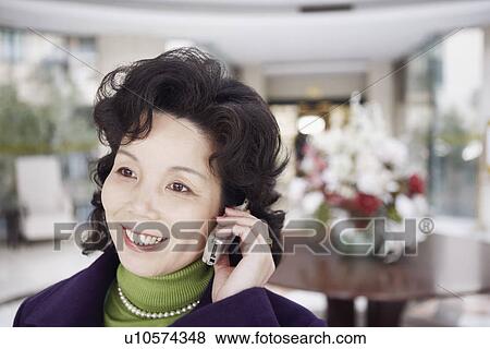 Stock Photo - Close-up of a mature woman talking on a mobile phone. Fotosearch