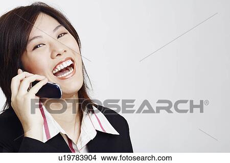 Portrait of a businesswoman talking on a mobile phone View Large Photo Image Picture - Portrait of a businesswoman talking on a mobile phone. Fotosearch